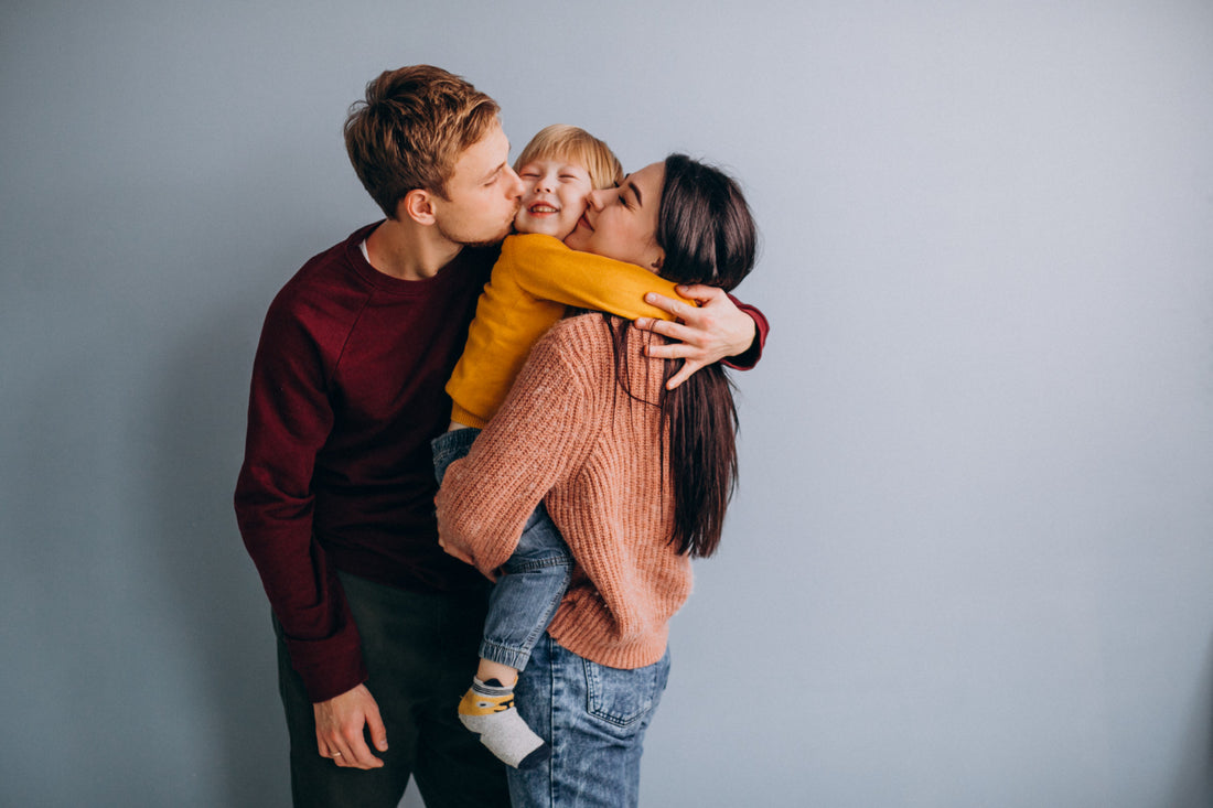 Two young parents cuddling their son to support his mental health
