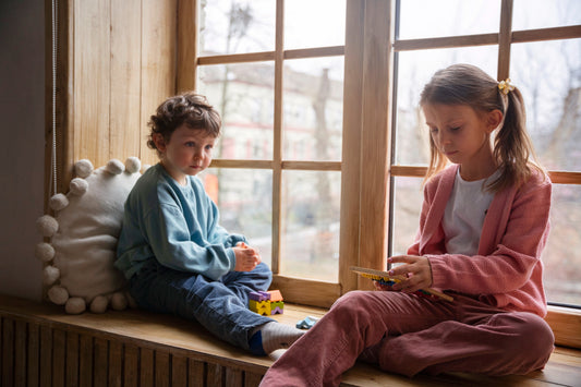 Children playing by window to highlight Children's Mental Health Week 2025