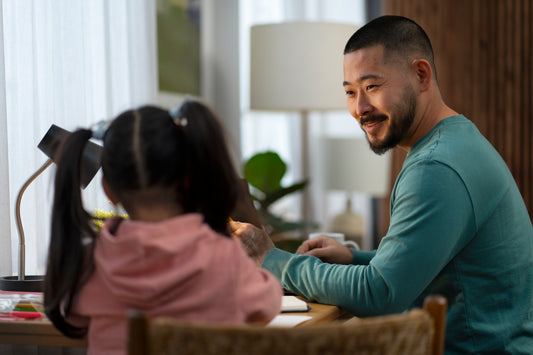 Parent talking to their child at the table to nurture their mental health