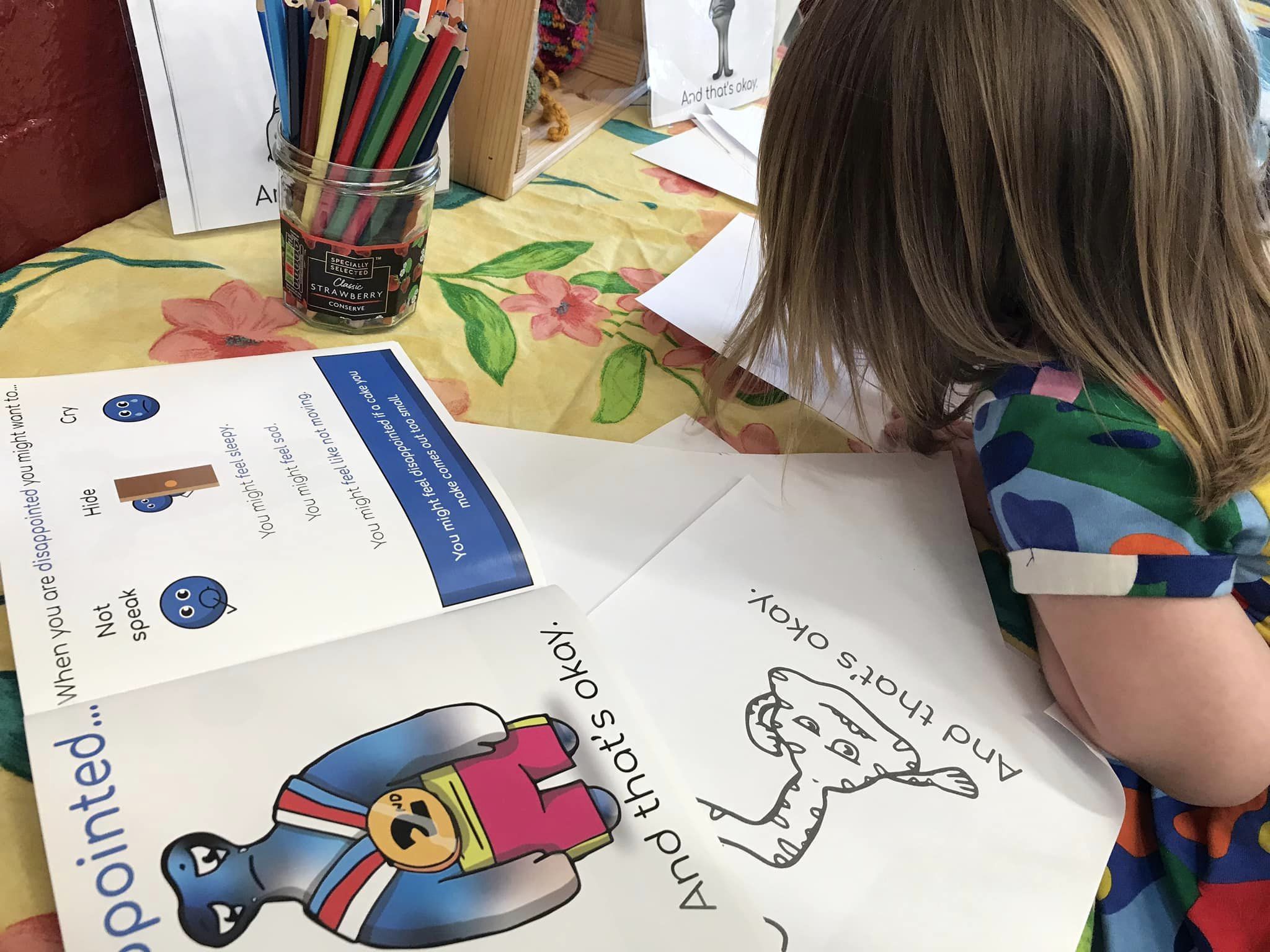 Child at Openwoodgate Preschool colouring in a mental health colouring sheet.