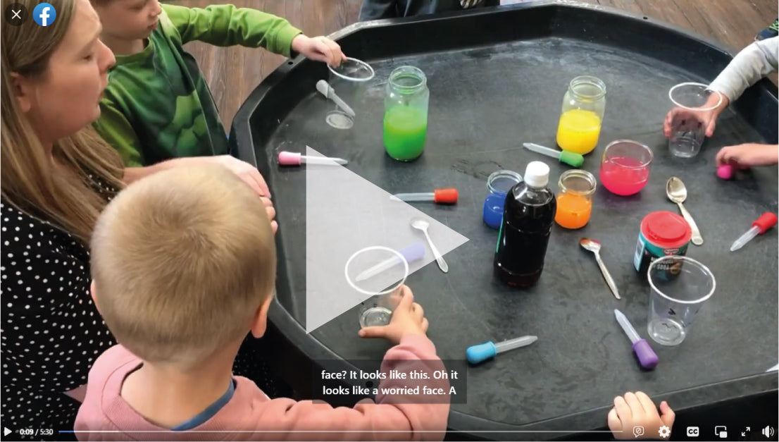 Children and the team at Openwoodgate Preschool taking part in a children's mental health activity using coloured paints and vinegar