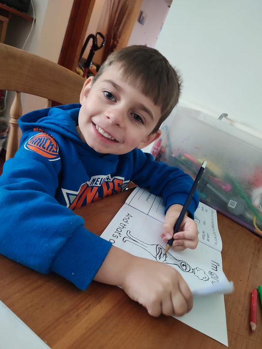 Boy enjoying the That's Okay emotions colouring book