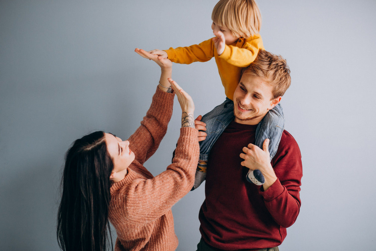 Photo of parents high fiving child to illustrate strategies for youth emotional support