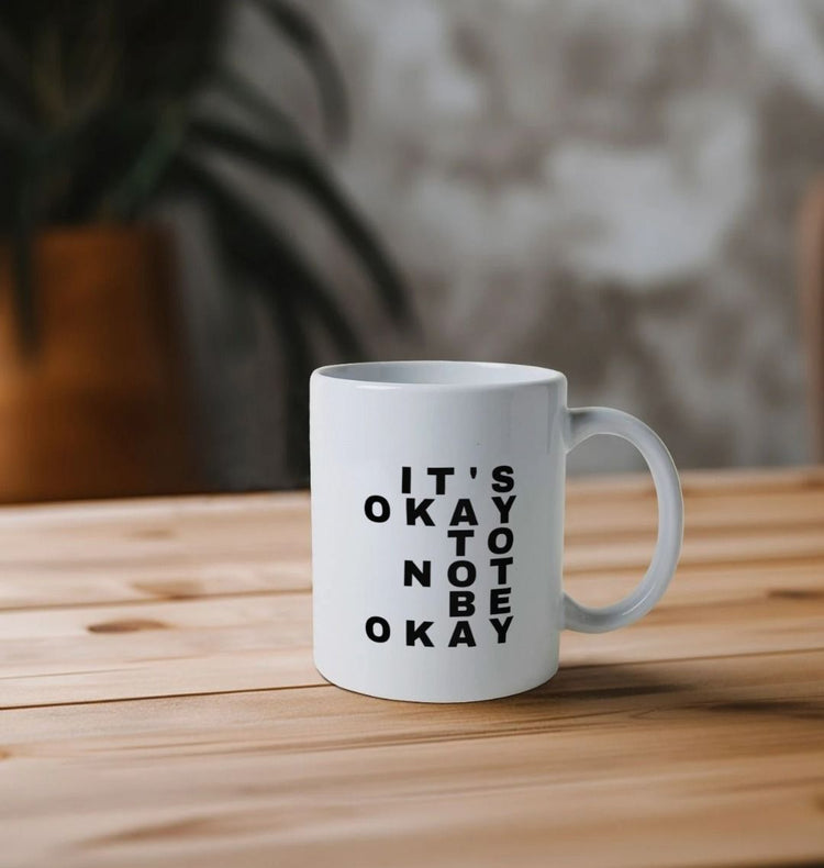 A close-up of a stylish ceramic mug featuring a witty quote, perfect for coffee or tea lovers seeking a personal touch in their drinkware.